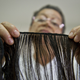A former cancer patient weaves natural hair to make wigs on World Cancer Day on Feb. 4, 2014, at a foundation in Cali, Colombia. (Luis Robayo/AFP/Getty Images)